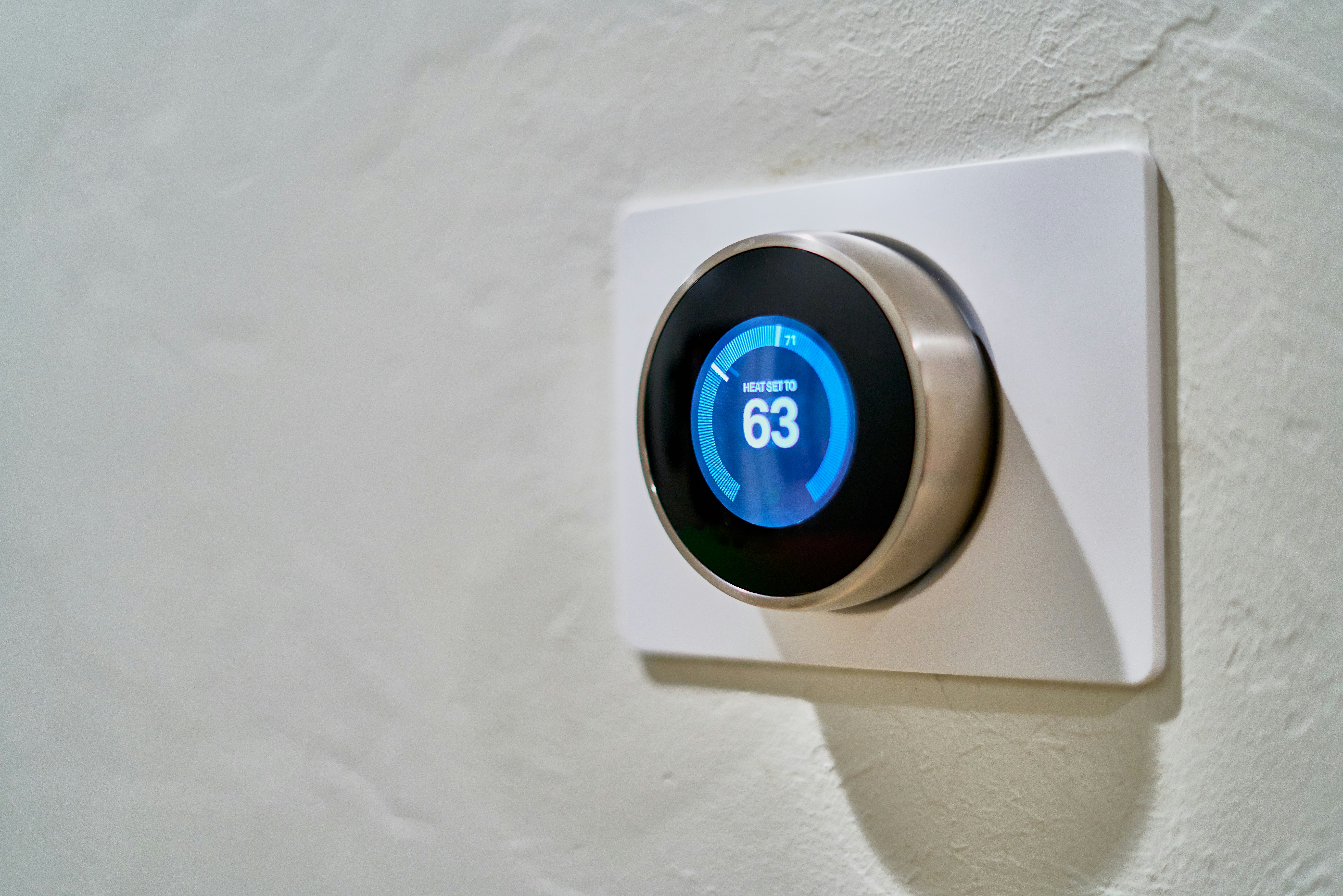 A smart thermostat installed on a wall at Co/Op Tech Ridge apartment complex,
showcasing modern, energy-efficient technology available for residents.