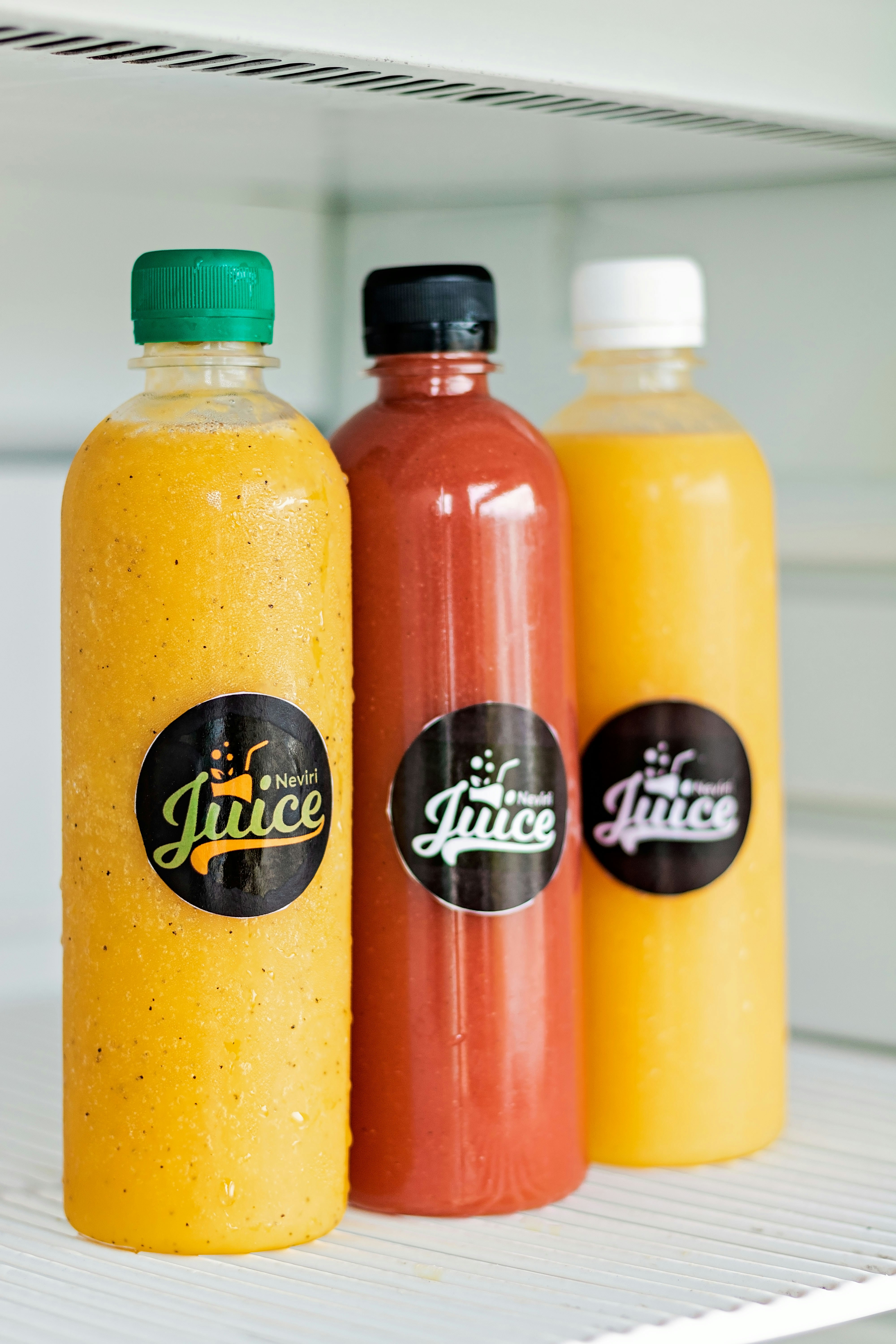 Fresh juice bottles in a refrigerator at Co/Op Tech Ridge, Manor, TX